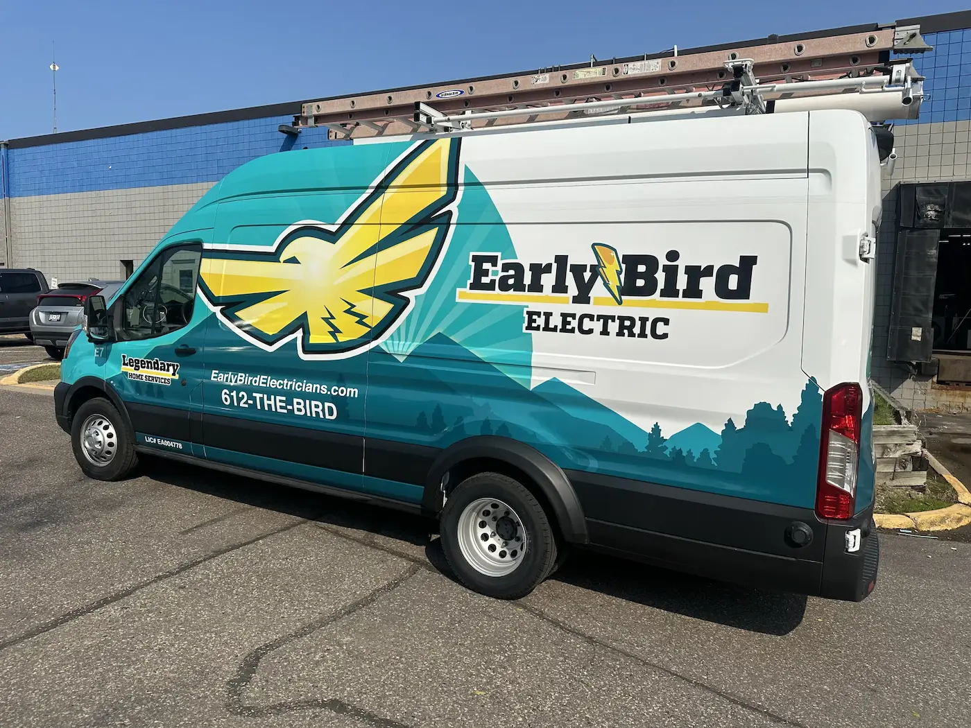 EarlyBird Electric branded service van parked outside commercial building for electrical services in Minneapolis, MN