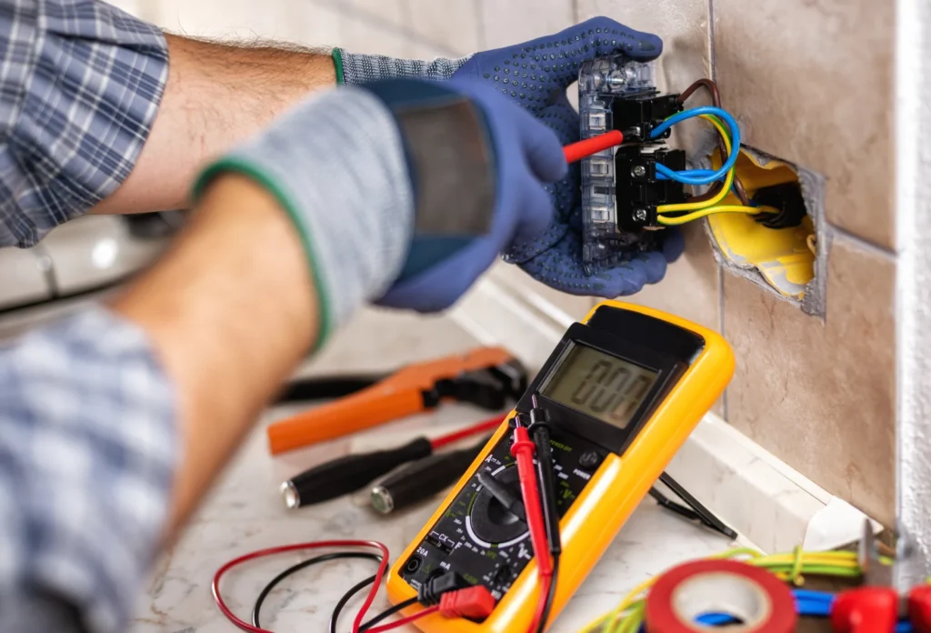 Electrician testing wiring with multimeter