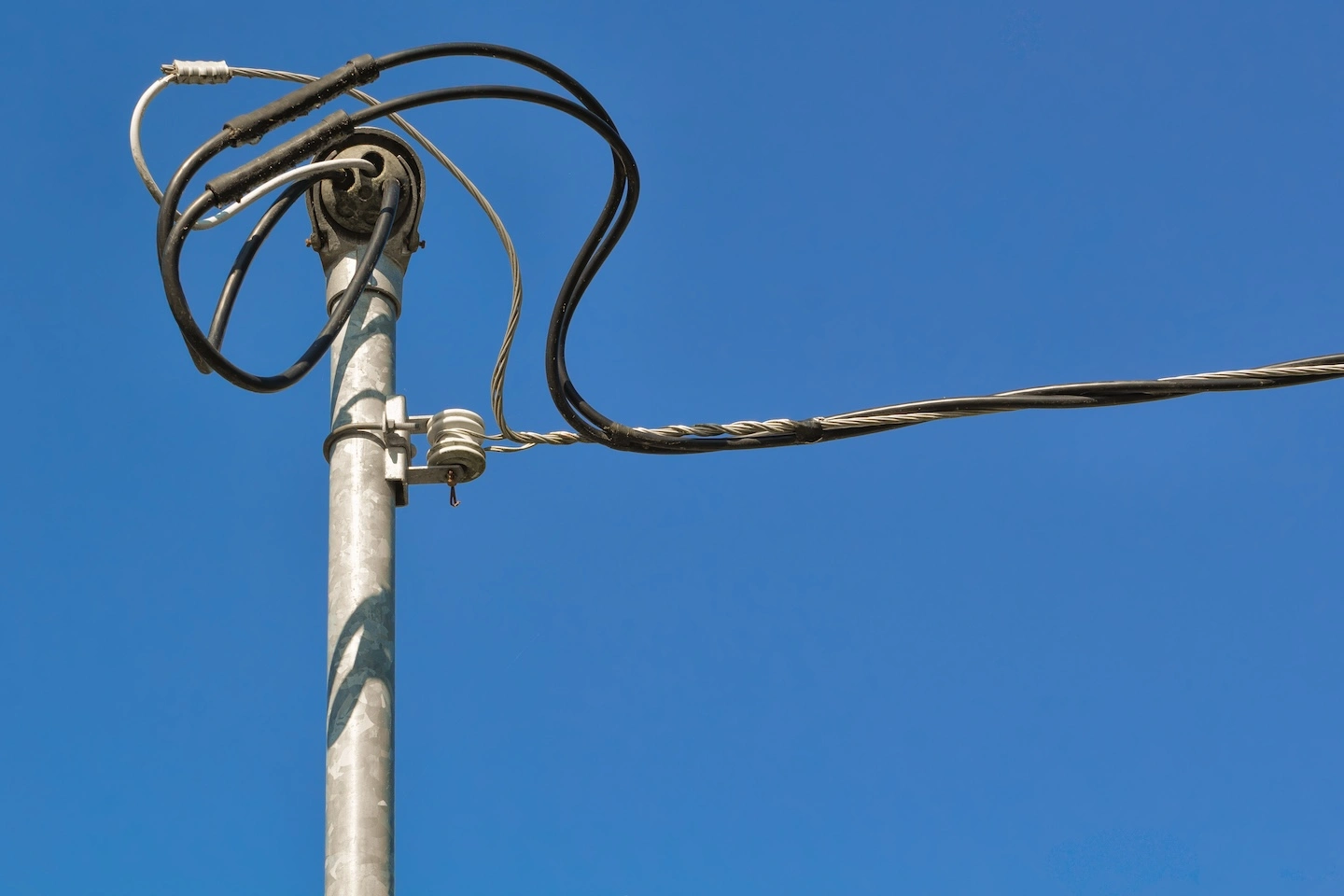 Electrical service mast and overhead power line connection on residential home in Minneapolis, MN